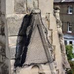Debris netting on church loose masonry